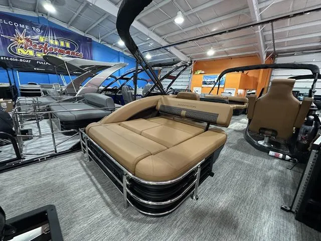 Slide: The Image of 2025 Bennington M Swingback 24 MSB pontoon boat with tan seating in showroom. - 17