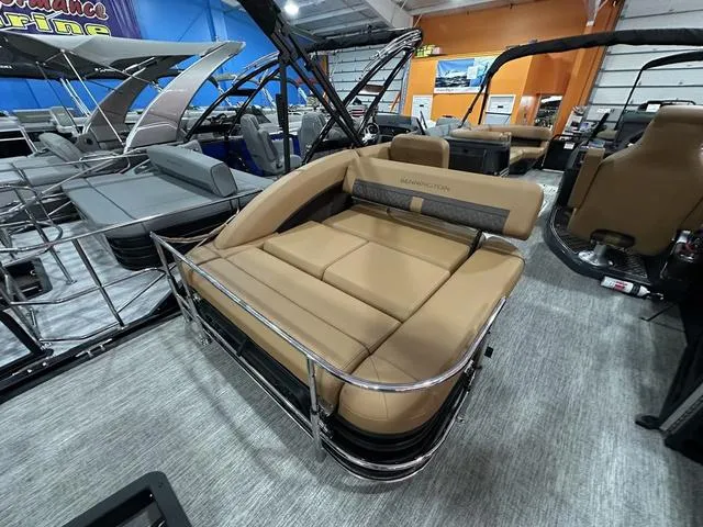 Slide: The Image of 2025 Bennington M Swingback 24 MSB pontoon boat with tan seating in showroom. - 18