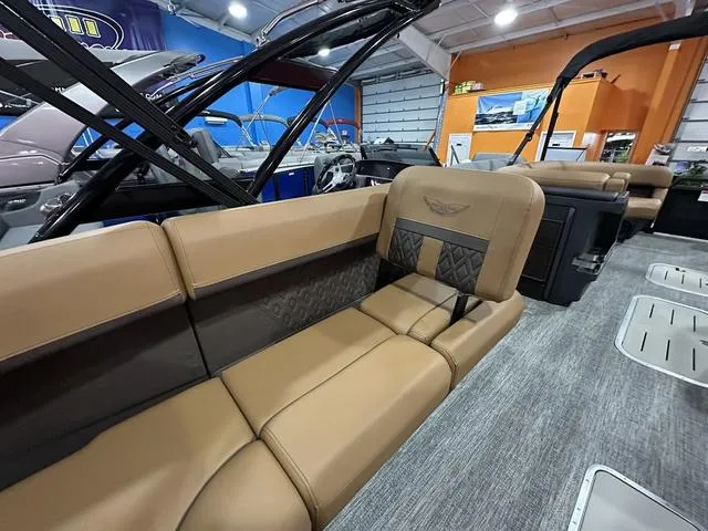 Slide: The Image of 2025 Bennington M Swingback 24 MSB boat with Yamaha outboard motor in showroom. - 21