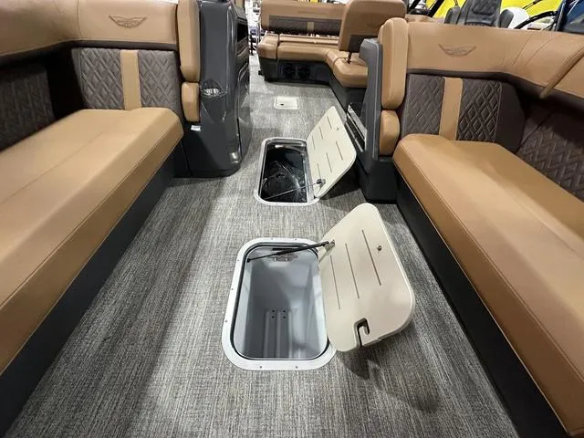 Slide: The Image of 2025 Bennington M Swingback 24 MSB interior with open storage compartments and luxurious seating. - 25