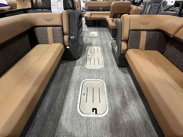 Slide: The Image of 2025 Bennington M Swingback 24 MSB interior with luxurious tan seating and modern flooring. - 26