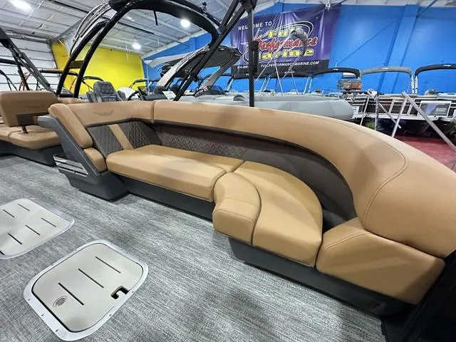 Slide: The Image of 2025 Bennington M Swingback 24 MSB pontoon boat interior with luxurious tan seating. - 27