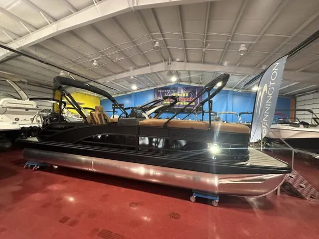 Slide: The Image of 2025 Bennington M Swingback 24 MSB pontoon boat in showroom, sleek design, luxurious seating. - 3