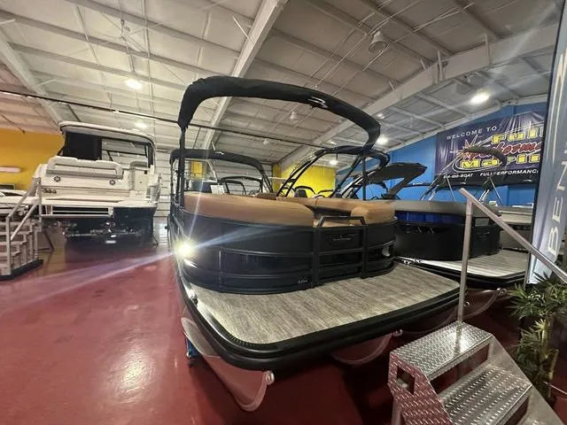 Slide: The Image of 2025 Bennington M Swingback 24 MSB pontoon boat in showroom, front view. - 4