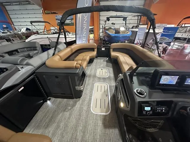 Slide: The Image of 2025 Bennington M Swingback 24 MSB pontoon boat interior with tan seating and modern design. - 9