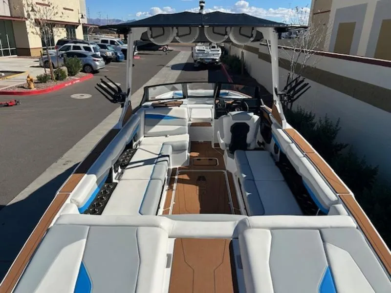 Slide: The Image of 2025 Axis A245 boat with spacious seating and modern design in a parking area. - 10