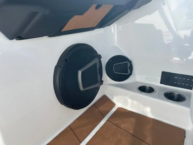 Slide: The Image of 2025 Axis A245 boat interior with speakers and cup holders. - 14