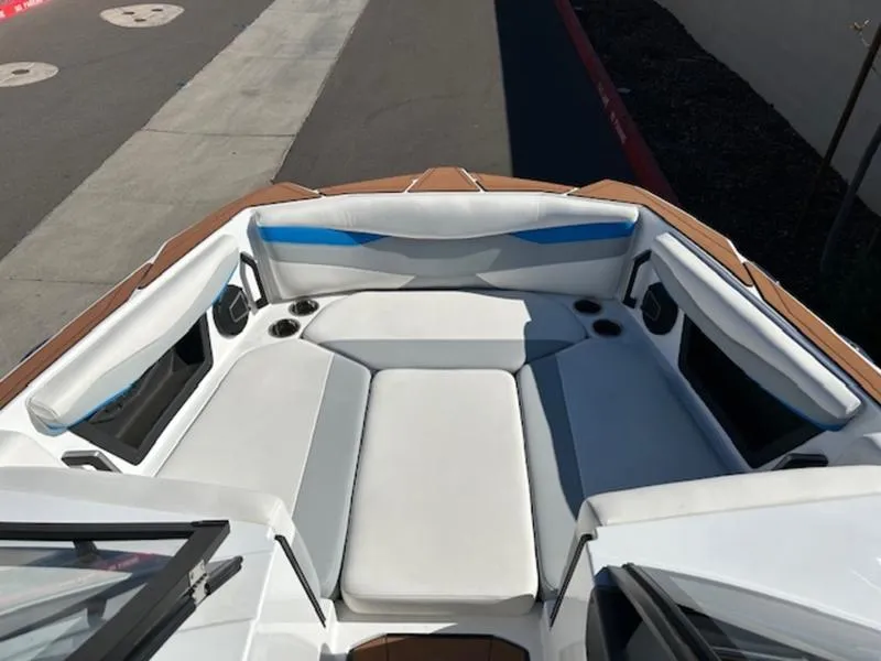 Slide: The Image of 2025 Axis A245 boat interior with white seating and cup holders. - 15