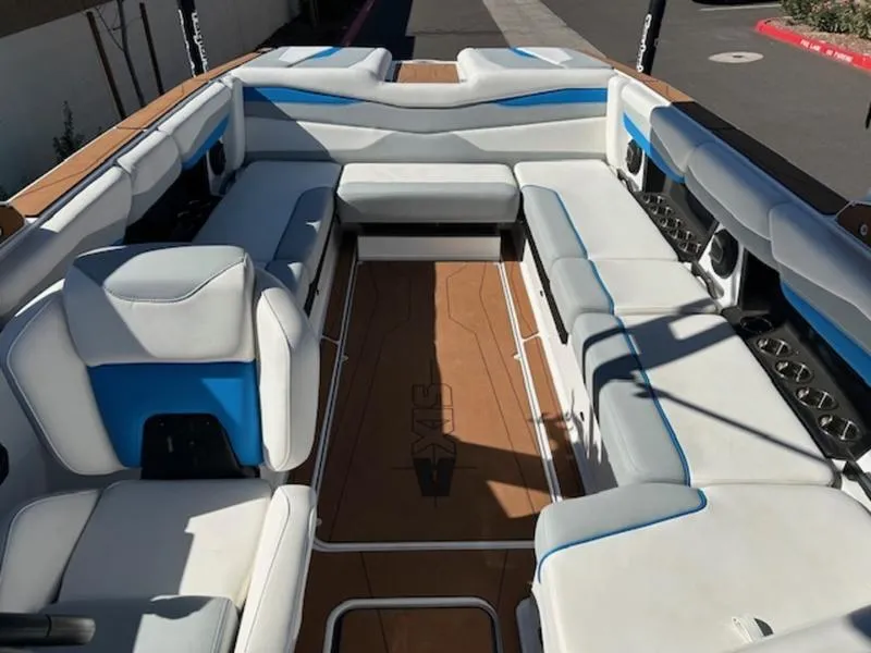 Slide: The Image of 2025 Axis A245 boat interior with white and blue seating, spacious layout. - 19