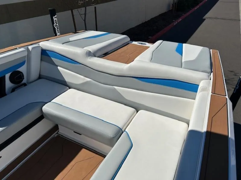 Slide: The Image of 2025 Axis A245 boat interior with white and blue cushioned seating. - 21
