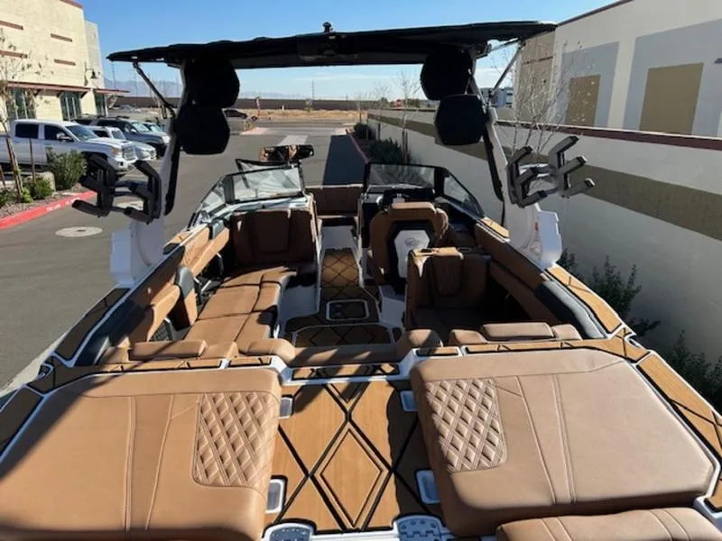 Slide: The Image of 2025 Malibu M242 boat interior with luxurious tan seating and modern design. - 11