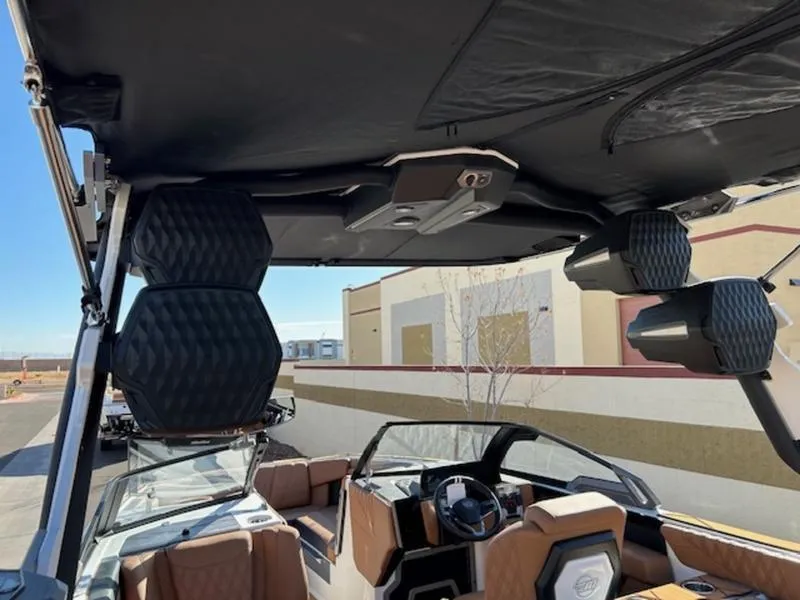 Slide: The Image of 2025 Malibu M242 boat interior with premium seating and advanced audio system. - 12