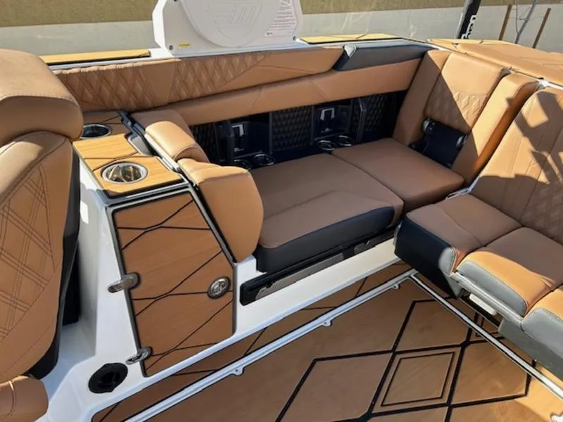 Slide: The Image of 2025 Malibu M242 boat interior with luxurious tan leather seating and modern design. - 19