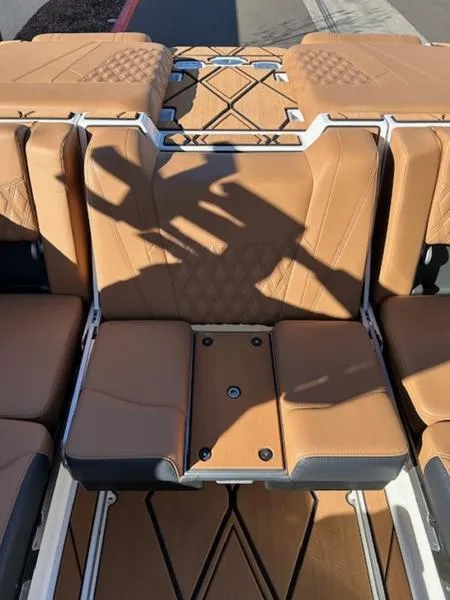 Slide: The Image of 2025 Malibu M242 boat interior with tan leather seats and modern design. - 21