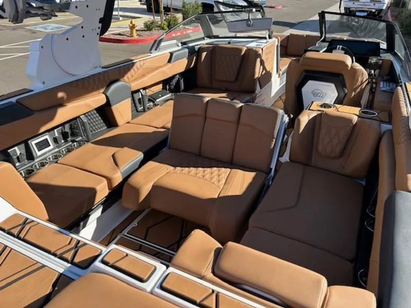 Slide: The Image of 2025 Malibu M242 boat interior with luxurious tan leather seating and modern design. - 22