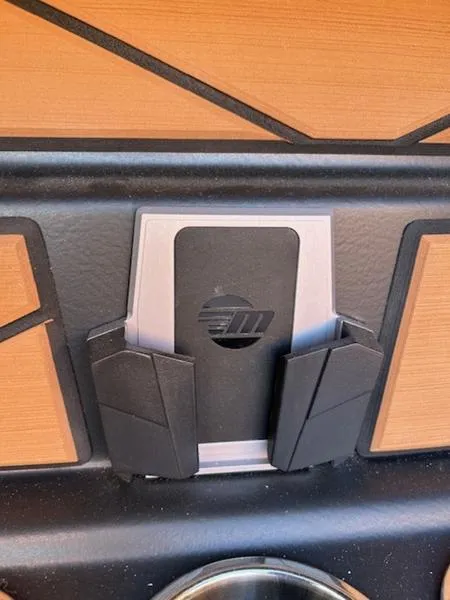 Slide: The Image of 2025 Malibu M242 interior detail with phone holder and wood accents. - 28