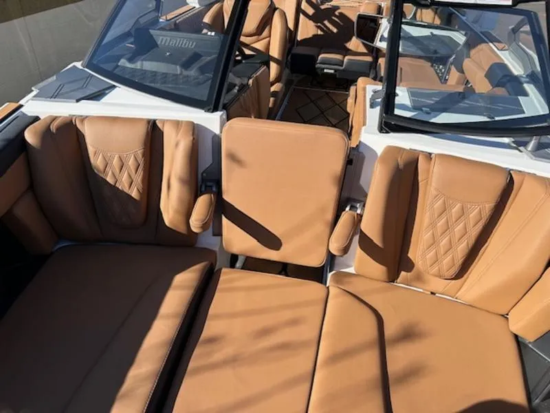 Slide: The Image of 2025 Malibu M242 boat interior with luxurious tan leather seating. - 29