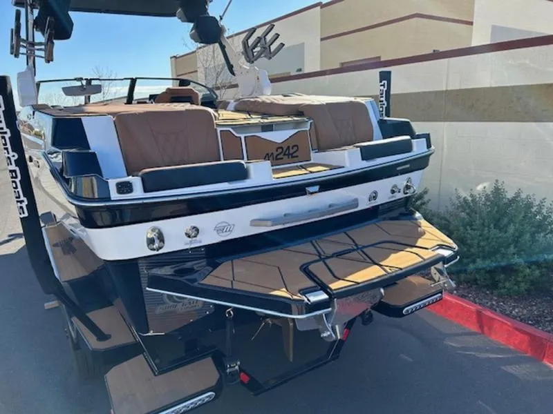 Slide: The Image of 2025 Malibu M242 boat, rear view with sleek design and modern features. - 6