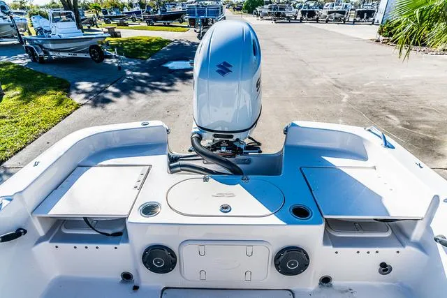 Slide: The Image of 2025 Carolina Skiff 21LS boat with outboard motor, spacious deck, and storage compartments. - 16