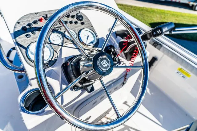 Slide: The Image of 2025 Carolina Skiff 21LS boat steering wheel and dashboard controls. - 4