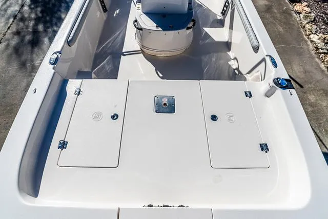 Slide: The Image of 2025 Carolina Skiff 21LS boat interior with storage compartments and seating. - 6