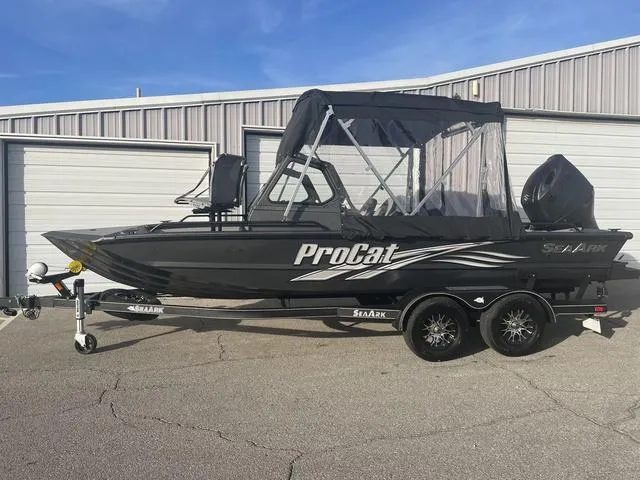 Slide: The Image of 2025 SeaArk Pro Cat 200 boat with canopy on a trailer, parked outdoors. - 1