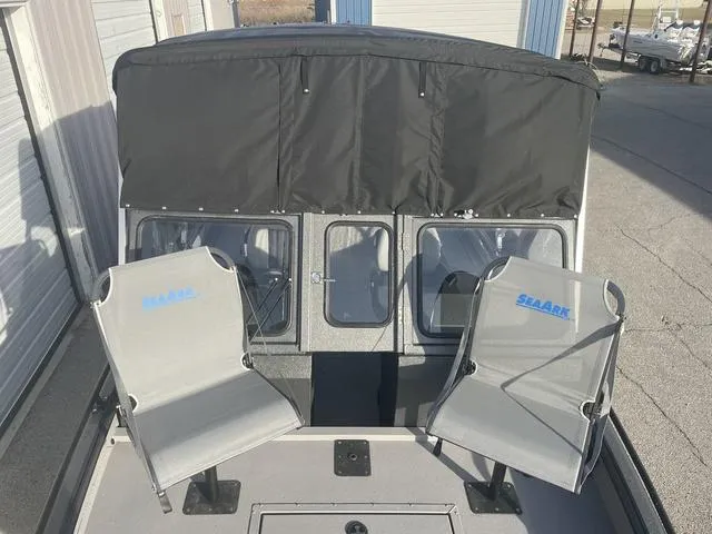 Slide: The Image of 2025 SeaArk Pro Cat 200 boat with two seats and a covered cabin. - 10