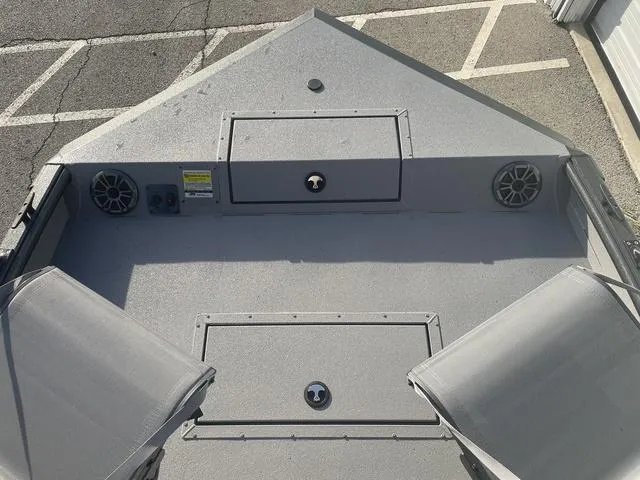 Slide: The Image of 2025 SeaArk Pro Cat 200 boat deck with storage compartments and speakers. - 12