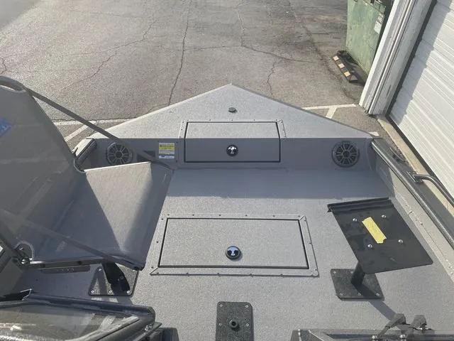 Slide: The Image of 2025 SeaArk Pro Cat 200 boat deck with seating and storage compartments. - 13