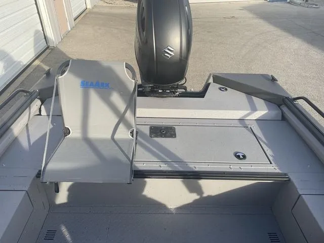 Slide: The Image of 2025 SeaArk Pro Cat 200 boat interior with Suzuki engine, featuring seating and storage. - 16