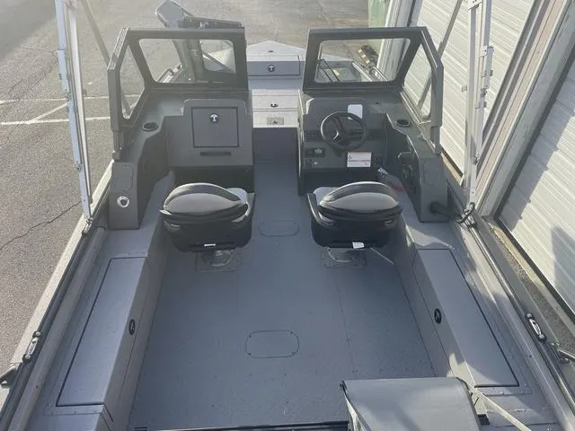 Slide: The Image of 2025 SeaArk Pro Cat 200 boat interior with dual seats and steering console. - 19