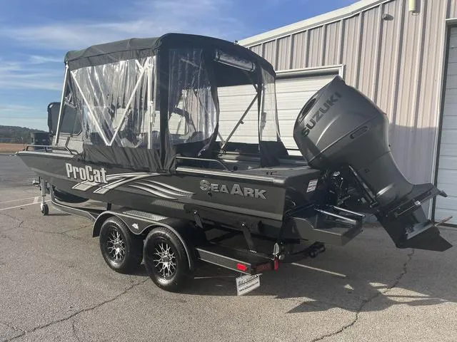 Slide: The Image of 2025 SeaArk Pro Cat 200 boat with Suzuki outboard motor, parked outside a building. - 3