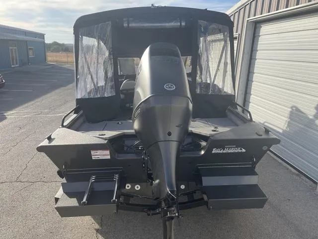 Slide: The Image of 2025 SeaArk Pro Cat 200 boat with outboard motor, parked near a garage. - 4