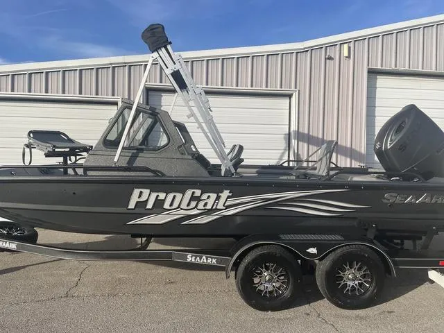 Slide: The Image of 2025 SeaArk Pro Cat 200 boat on trailer, parked outside a warehouse. - 5