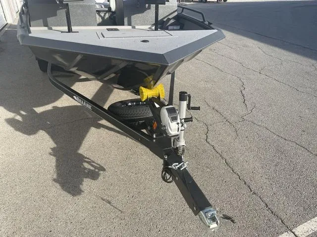 Slide: The Image of 2025 SeaArk Pro Cat 200 boat trailer on pavement, front view. - 9