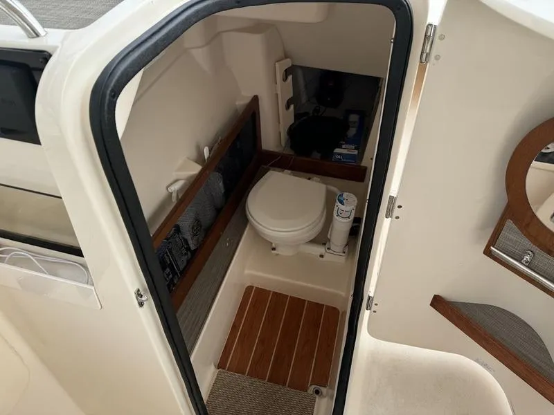 Slide: The Image of 2022 Grady-White 275 Freedom boat interior with compact marine toilet. - 11