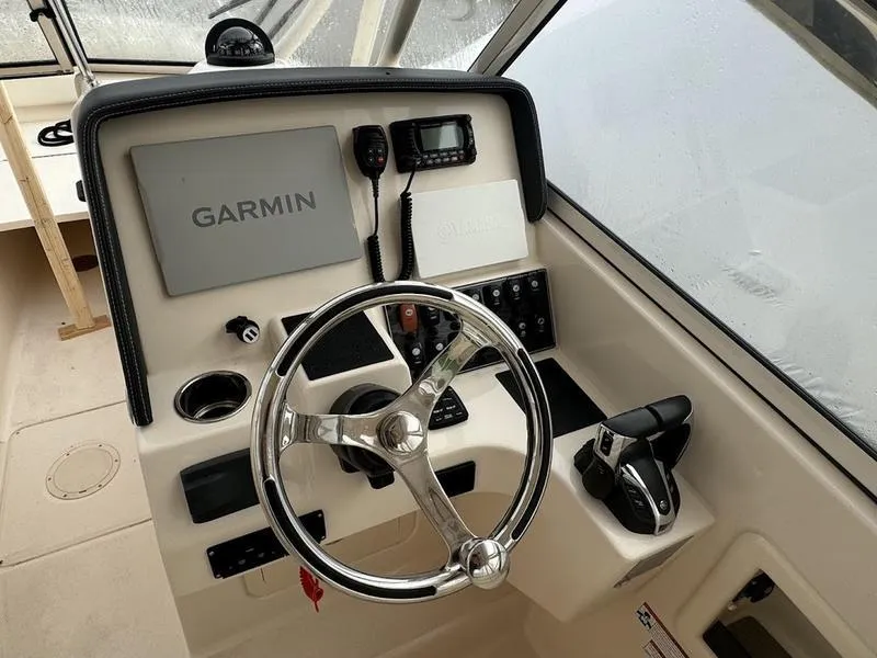 Slide: The Image of 2022 Grady-White 275 Freedom boat helm with Garmin navigation system and controls. - 12