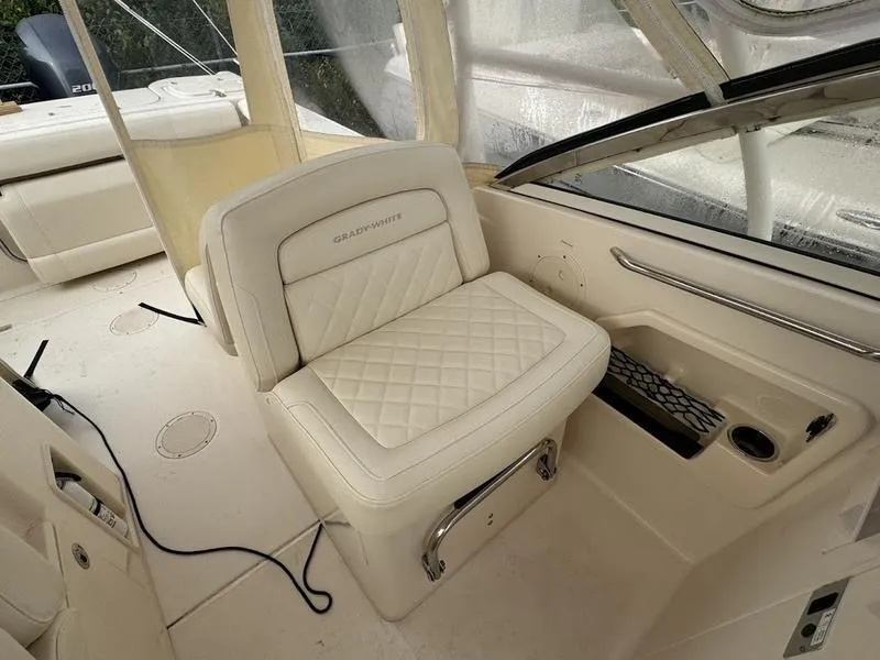 Slide: The Image of 2022 Grady-White 275 Freedom boat interior with cushioned seating and storage. - 15