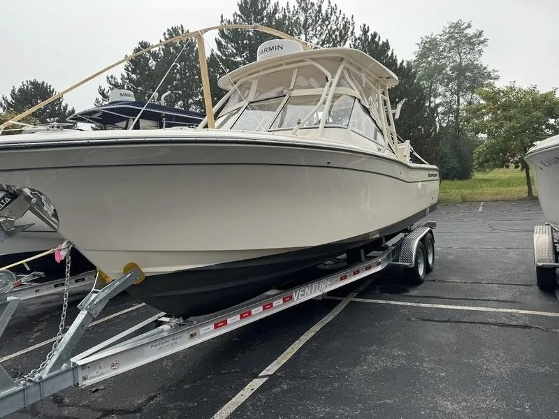 Slide: The Image of 2022 Grady-White 275 Freedom boat on trailer in parking lot. - 16