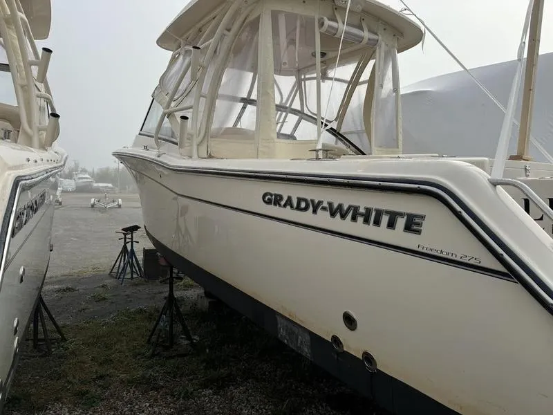 Slide: The Image of 2022 Grady-White 275 Freedom boat on stands in a foggy outdoor setting. - 4