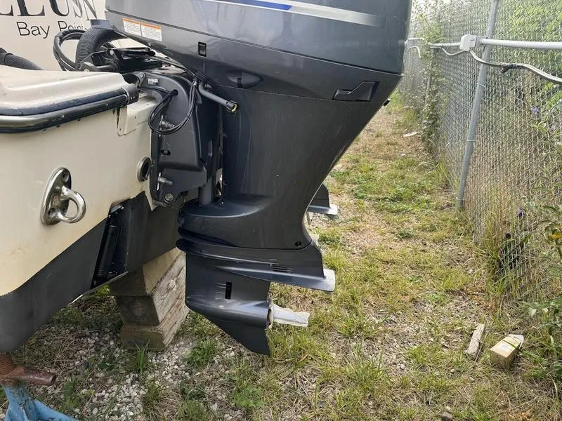 Slide: The Image of 2022 Grady-White 275 Freedom boat with dual outboard motors, parked on grass. - 5