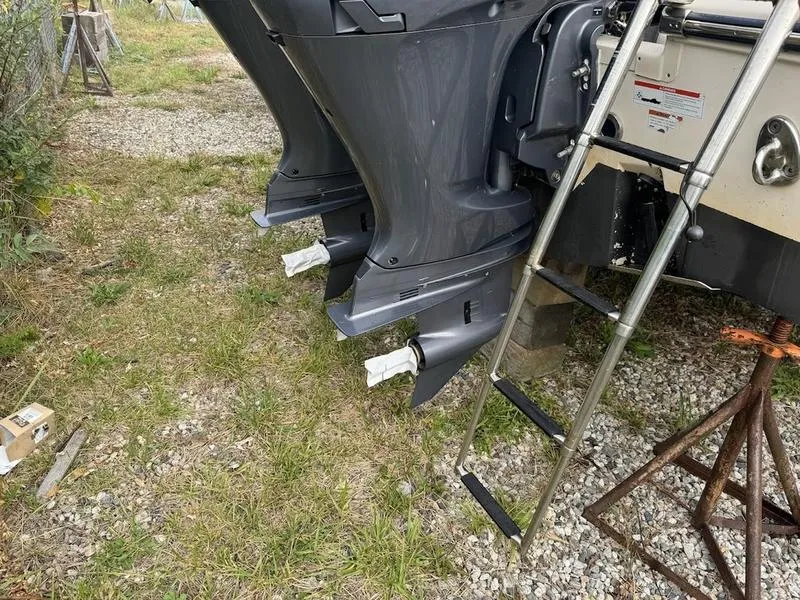 Slide: The Image of Grady-White 275 Freedom 2022 boat engines and ladder on grassy ground. - 6