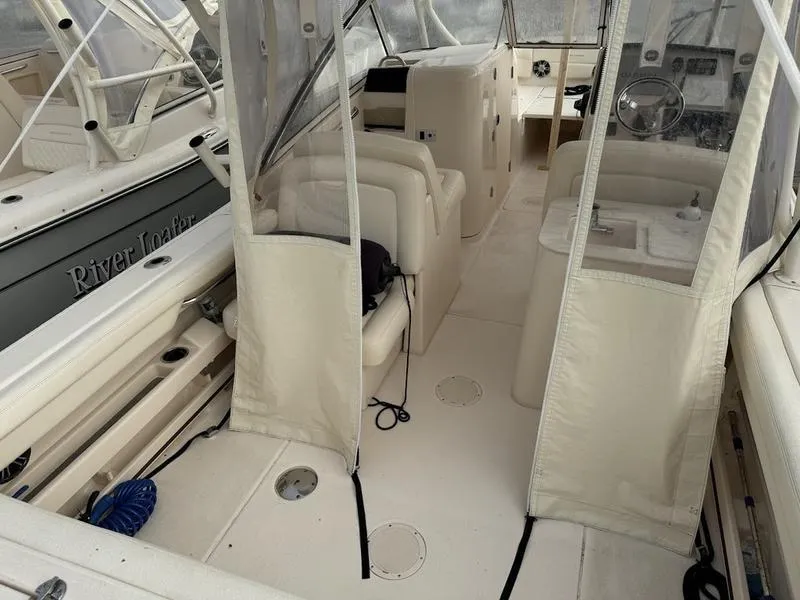 Slide: The Image of 2022 Grady-White 275 Freedom boat interior with seating and steering wheel. - 7