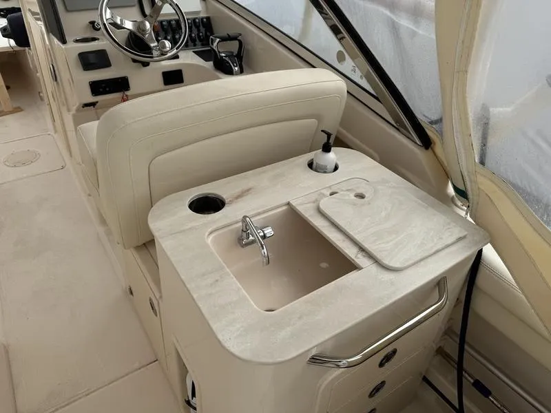 Slide: The Image of 2022 Grady-White 275 Freedom boat interior with sink and steering console. - 9