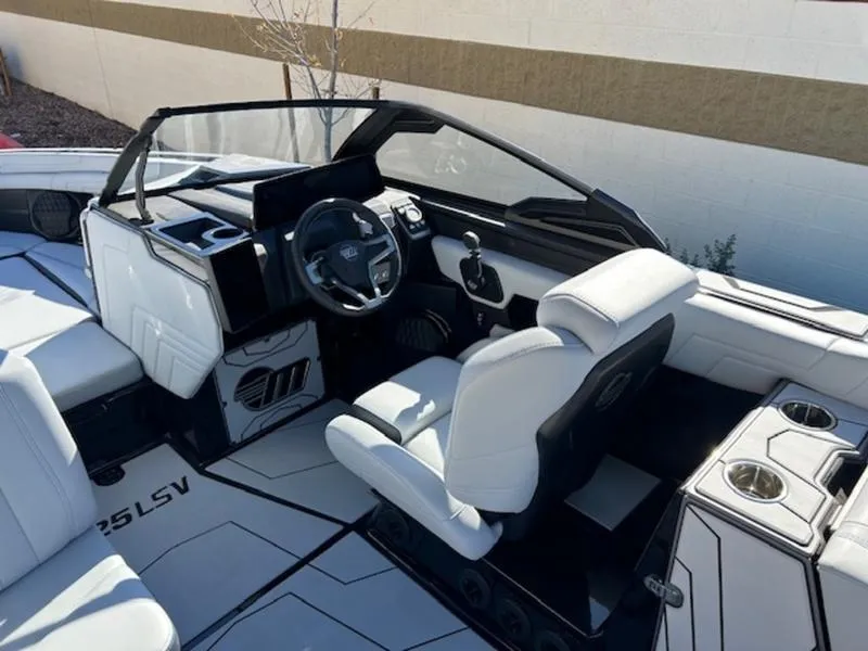 Slide: The Image of 2025 Malibu 25 LSV boat interior with sleek white seating and modern dashboard. - 13