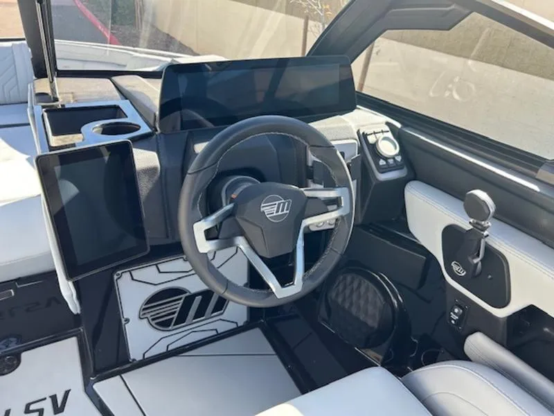 Slide: The Image of 2025 Malibu 25 LSV boat interior with modern steering wheel and dashboard. - 14