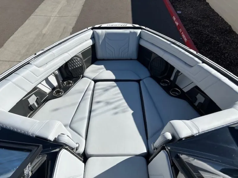 Slide: The Image of 2025 Malibu 25 LSV boat interior with luxurious seating and cup holders. - 17