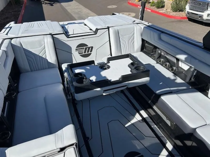 Slide: The Image of 2025 Malibu 25 LSV boat interior with sleek seating and modern design. - 20