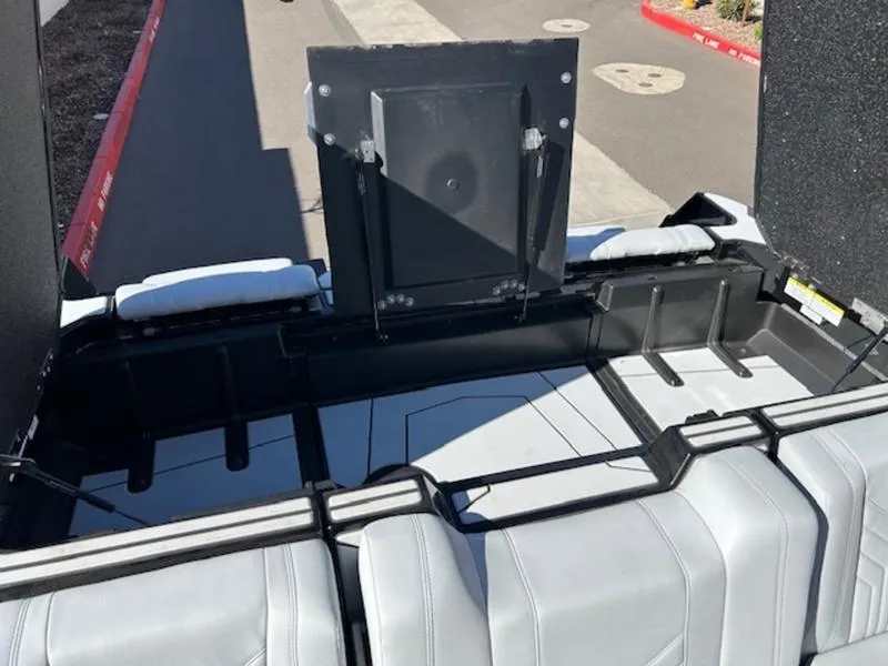 Slide: The Image of 2025 Malibu 25 LSV boat interior with sleek seating and storage compartments. - 23