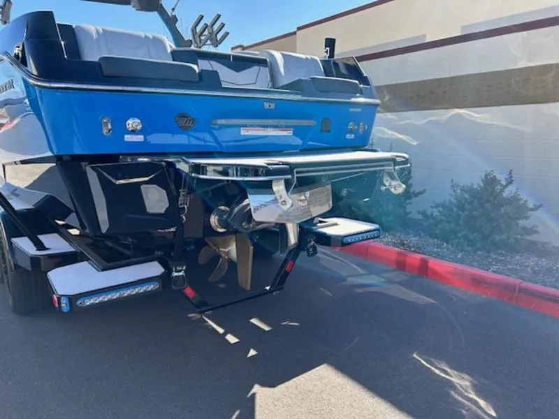 Slide: The Image of 2025 Malibu 25 LSV boat rear view, showcasing propeller and sleek blue design. - 4